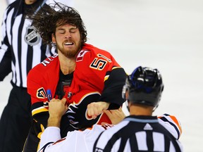 Calgary Flames Scott Sabourin fights Evan Polei of the Edmonton Oilers during NHL pre-season hockey at the Scotiabank Saddledome in Calgary on Monday, September 17, 2018. Al Charest/Postmedia