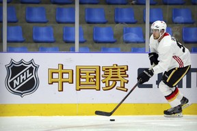 Sam Bennett of the Calgary Flames skates with the puck during a team practice in Beijing, China, Monday, Sept. 17, 2018. The Flames faced off against the Boston Bruins in southern Chinese city of Shenzhen on Saturday and will play the Bruins again in Beijing on Wednesday in the 2018 NHL China Games. The sign reads "China Games". (AP Photo/Mark Schiefelbein) ORG XMIT: XMAS114