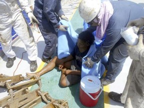 In this undated photo released by Indonesian Consulate General in Osaka, 18-year-old Aldi Novel Adilang sits on the deck of a Panamanian-flagged vessel, MV Arpeggio after being rescued in the waters near Guam. The Indonesian teenager has survived about 7 weeks adrift at sea after the floating wooden fish trap he was employed to mind slipped its moorings. Aldi's parents and the Indonesian Consulate in Osaka, Japan, said he was rescued by MV Arpeggio off Guam on Aug. 31 and returned to Indonesia earlier this month. (Indonesian Consulate General in Osaka via AP)