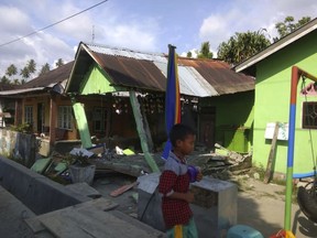 In this photo released by the Disaster Management Agency, a house sits damaged after a magnitude 6.1 earthquake early Friday, Sept. 28, 2018, in Donggala, central Sulawesi, Indonesia.