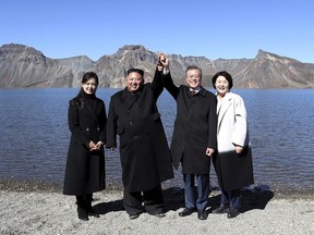 South Korean President Moon Jae-in, second from right, and his wife Kim Jung-sook, right, stand with North Korean leader Kim Jong Un, second from left, and his wife Ri Sol Ju on the Mount Paektu in North Korea, Thursday, Sept. 20, 2018.