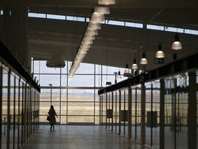A long shopper walks through the empty corridors of New Horizon Mall north of Calgary. The mall has had difficulty attracting vendors.