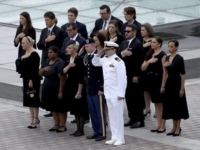 Members of the McCain family watch as a military honour guard team carries the casket of Sen. John McCain, R-Ariz., from the U.S. Capitol, Saturday, Sept. 1, 2018 in Washington.