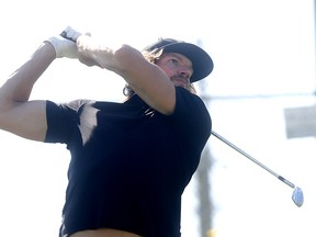 Calgary Flames goalie Mike Smith drives the ball at the Calgary Flames Celebrity Charity Golf Classic at the Country Hills Golf Club on Thursday, Sept. 6, 2018.