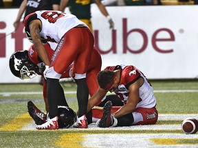 Dejected Calgary Stampeders after a missed hail mary in the end zone by Juwan Brescacin (sitting) with teammates Reggie Begelton (84) and Lemar Durant (1) during CFL action at Commonwealth Stadium in Edmonton, September 8, 2018. Ed Kaiser/Postmedia
