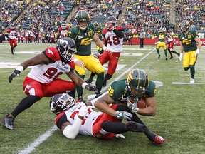 Calgary Stampeders Tunde Adeleke takes down Edmonton Eskimos Jordan Robinson during first half CFL action in Edmonton on Saturday Sept. 8, 2018.