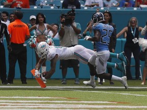Miami Dolphins wide receiver Kenny Stills (10) scores a touchdown ahead of Tennessee Titans cornerback Adoree' Jackson (25) Sunday, Sept. 9, 2018, in Miami Gardens, Fla.