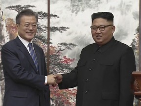 In this image made from video provided by Korea Broadcasting System (KBS), North Korean leader Kim Jong Un, right, and South Korean President Moon Jae-in shake hands at the end of their joint press conference in Pyongyang, North Korea Wednesday, Sept. 19, 2018. (Korea Broadcasting System via AP)