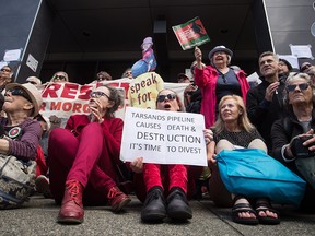 Protesters opposed to the Kinder Morgan Trans Mountain pipeline extension demonstrate outside Justice Minister Jody Wilson-Raybould's constituency office, in Vancouver on June 4, 2018.