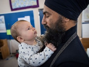 NDP Leader Jagmeet Singh holds Laurier LeSieur, 5 months, while speaking with his parents during a visit to the Rumble on Gray Street Fair, in Burnaby, B.C., on Saturday Sept. 15, 2018.