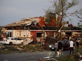 People collect personal effects from damaged homes following a tornado in Dunrobin, Ontario west of Ottawa on Friday, Sept. 21, 2018. A tornado damaged cars in Gatineau, Que., and houses in a community west of Ottawa on Friday afternoon as much of southern Ontario saw severe thunderstorms and high wind gusts, Environment Canada said.