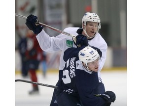 Buddy Robinson, then with the Winnipeg Jets, gives teammate Jansen Harkins the business during  training camp in this September 2017 file photo. Postmedia file photo