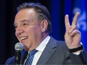 Quebec premier-designate Francois Legault gestures as he addresses a meeting of his new caucus and defeated candidates in Boucherville, Que., on Wednesday, Oct. 3, 2018.