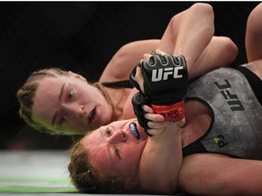 Aspen Ladd has a choke hold on Tonya Evinger in their women’s bantamweight bout during the UFC 229 event inside T-Mobile Arena on October 6, 2018 in Las Vegas, Nevada.
