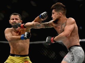 Sergio Pettis (R) punches Jussier Formiga of Brazil (L) in their flyweight bout during the UFC 229 event inside T-Mobile Arena on October 6, 2018 in Las Vegas, Nevada.