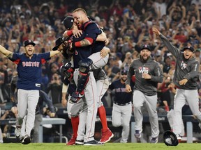 Christian Vazquez #7 jumps into the arms of Chris Sale #41 of the Boston Red Sox to celebrate their 5-1 win over the Los Angeles Dodgers in Game Five to win the 2018 World Series at Dodger Stadium on October 28, 2018 in Los Angeles, California.