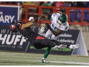 Calgary Stampeders Lemar Durant gets hammered by Saskatchewan Roughriders Mike Edem in CFL action at McMahon Stadium in Calgary, Alta.. on Saturday. The Stamps lost to Saskatchewan 29-24. Photo by Mike Drew/Postmedia