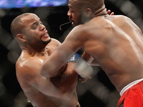 Daniel Comier (L) fends off an attack by light heavyweight champion Jon Jones during the UFC 182 event at the MGM Grand Garden Arena on January 3, 2015 in Las Vegas, Nevada.