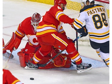 Calgary Flames Mike Smith looks for a lose puck in traffic during game action against the Boston Bruins at the Scotiabank Saddledome in Calgary on Wednesday October 17, 2018.