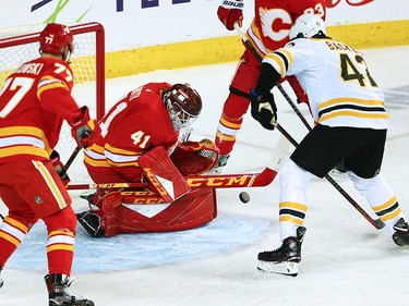 Calgary Flames goaltender Mike Smith stops this shot in front of the Boston Bruins' David Backes during NHL action at the Scotiabank Saddledome in Calgary on Wednesday October 17, 2018.