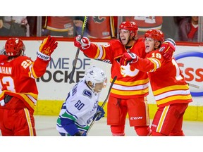 Calgary Flames forward Elias Lindholm celebrates with teammates after scoring against the Vancouver Canucks in NHL hockey at the Scotiabank Saddledome in Calgary on Saturday, October 6, 2018. Al Charest/Postmedia
