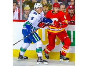 Vancouver Canucks forward Jake Virtanen battles against Juuso Valimaki of the Calgary Flames during NHL hockey at the Scotiabank Saddledome in Calgary on Saturday, October 6, 2018. Al Charest/Postmedia