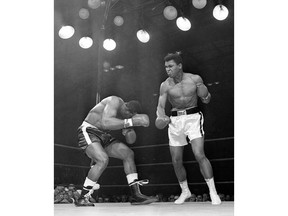 FILE - In this May 25, 1965, file photo, challenger Sonny Liston, left, ducks under a blow from heavyweight champion Muhammad Ali in the opening seconds of the first round of their title fight in Lewiston, Maine. Ali knocked Liston out in the first round to retain his title. The bout produced one of the strangest finishes in boxing history as well as one of sports' most iconic moments.  (AP Photo/File) ORG XMIT: POS2016060317072110      Muhammad Ali options ORG XMIT: POS1606031709120302