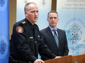 New interim Calgary police chief Steve Barlow answers questions at the Calgary Police Commission offices on Tuesday, Oct. 9, 2018. Brian Thiessen, Calgary Police Commission chair, 
stands behind Barlow.