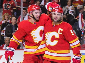 T.J. Brodie, left, celebrates a goal with Mark Giordano against Vancouver on Oct. 6, 2018. The pair will be reunited in Montreal on Tuesday.