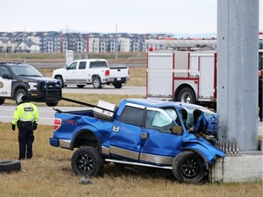 Police investigate the scene of a fatal collision where a truck hit a pole on northbound Stoney Trail between Highway 22X and 114th Avenue S.E. on Sunday morning September 30, 2018. Gavin Young/Postmedia