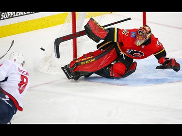 The Calgary Flames goaltender Mike Smith makes a big save on Washington Capitals star Alex Ovechkin during NHL action at the Scotiabank Saddledome in Calgary on Saturday October 27, 2018.