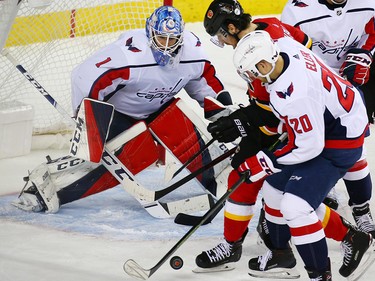 Players scramble in front of Washington Capitals goaltender Pheonix Copley during NHL action against the Calgary Flames at the Scotiabank Saddledome in Calgary on Saturday October 27, 2018.