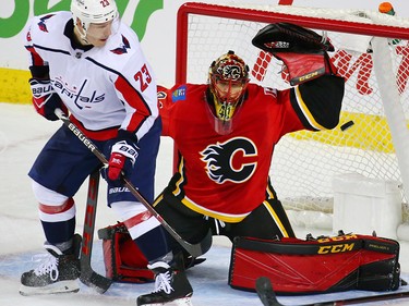Capitals forward Dmitrij Jaskin watches the puck pass Calgary Flames goaltender Mike Smith during NHL action at the Scotiabank Saddledome in Calgary on Saturday October 27, 2018. The Washington Capital's Matt Niskanen scored the goal on a shot from the blue line.