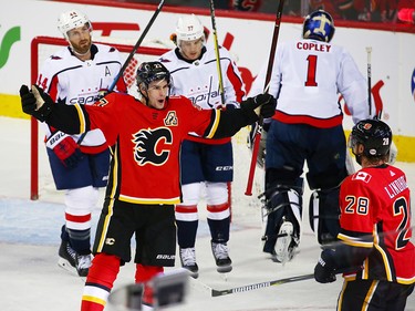 The Calgary Flames' Sean Monahan, left celebrates with Elias Lindholm after Lindholm scored on the Washington Capitals during NHL action at the Scotiabank Saddledome in Calgary on Saturday October 27, 2018.