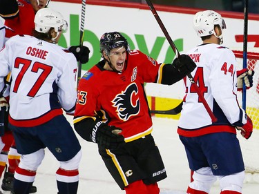 The Calgary Flames' Sean Monahan celebrates Elias Lindholm's goal on the Washington Capitals during NHL action at the Scotiabank Saddledome in Calgary on Saturday October 27, 2018.
