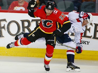 The Calgary Flames' Sam Bennett collides with the Washington Capitals' T.J. Oshie during NHL action at the Scotiabank Saddledome in Calgary on Saturday October 27, 2018.