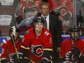 Assistant coach Geoff Ward watches the final moments of Thursday's 9-1 loss to the Pittsburgh Penguins at the Saddledome.