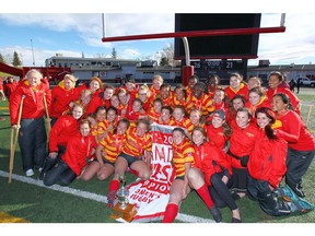 Members of the Calgary Dinos Women's Rugby team celebrate in Calgary on  Sunday, October 22, 2017 after defeating the Victoria Vikes 26-21 in the Canada West final. Jim Wells/Postmedia