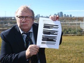Rick Bell holds a redacted copy of a Olympic document in Calgary on Wednesday, October 17, 2018. Jim Wells/Postmedia