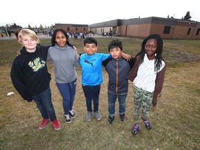 (L-R) Gerrit Surette, Nevaeh Lee, Daniel Mercader, Theo Minoso, Sophie Loding all grade 6 students at St Peter Elementary School, pose on the school playground in southeast Calgary on Thursday, October 18, 2018.. St Peter Elementary is one of four finalists in the Kraft Heinz Power Play contest to win $250,000 for a new playground, right now they have nothing. Jim Wells/Postmedia