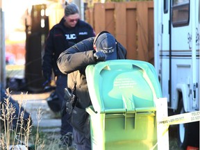 Police investigate in the alley at the scene of a shooting in 5800 Memorial Drive NE in Calgary on Sunday, October 21, 2018. Jim Wells/Postmedia