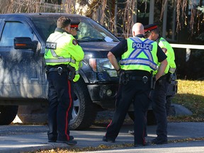 Police on the scene at Trafford Dr. N.W. where a man was struck by a vehicle. Photo by Al Charest, Postmedia Network