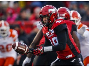 Calgary Stampeders quarterback Bo Levi Mitchell hands off the ball during CFL football action against the BC Lions, in Calgary, Saturday, Oct. 13, 2018.