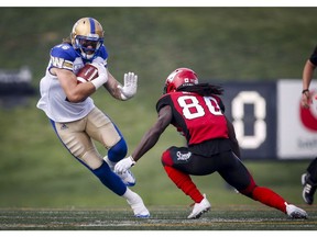 Winnipeg Blue Bombers' Taylor Loffler, left, dodges Calgary Stampeders' Marken Michel during first quarter CFL football action in Calgary on August 25, 2018. The Blue Bombers don't think the Calgary Stampeders are ripe for the picking ahead of Friday's game that could give Winnipeg a playoff spot with a victory or tie. The Bombers are riding a four-game winning streak while the Stampeders have lost two straight.