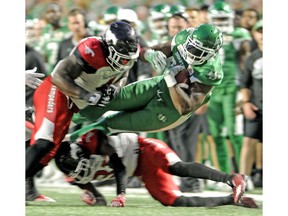 Saskatchewan Roughriders running back Jerome Messam is taken down during second half CFL action at Mosaic Stadium in Regina on Friday, July 28, 2018.