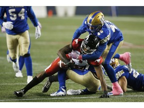 Winnipeg Blue Bombers' Jovan Santos-Knox (45) forces Calgary Stampeders' Chris Matthews (81) to fumble the ball during the first half of CFL action in Winnipeg, Friday, Oct. 26, 2018.