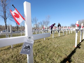 Hundreds of volunteers came out to place the crosses for the annual Field of Crosses program. November 1st to November 11th; over 3,400 crosses are being displayed on a 5 acre city park in military cemetery formation to memorialize Southern Alberta soldiers who were killed in action. (Memorial Drive between 3rd Street NW and Centre Street) on Saturday October 27, 2018. Darren Makowichuk/Postmedia