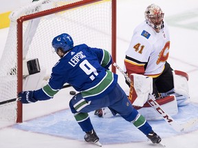 Vancouver Canucks Brendan Leipsic puts a shot past Flames goaltender Mike Smith during the third period at Rogers Arena in Vancouver, Wednesday, Oct, 3, 2018.