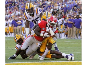 Georgia running back Elijah Holyfield (13) scores against LSU during the third quarter of an NCAA college football game Saturday, Oct. 13, 2018, in Baton Rouge, La. (Bob Andres/Atlanta Journal Constitution via AP) ORG XMIT: GAATJ332