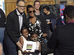 Alberta Finance Minister Joe Ceci celebrates with families taking possession of their new homes at a Habitat for Humanities build in Bowness. Courtesy, Habitat for Humanities.